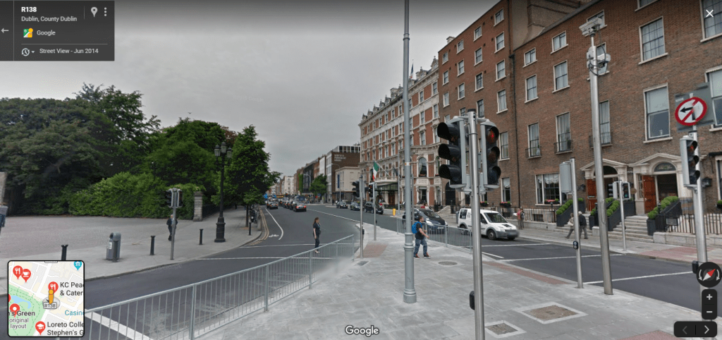 Google Street view of the same location as above, dating to 2014, showing modern people and vehicles.