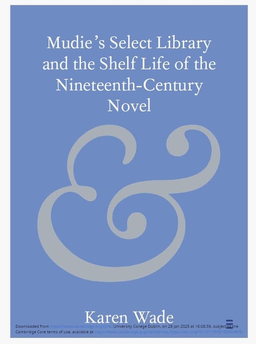 The cover of the book Mudie's Select Library and the Shelf Life of the Nineteenth-Century Novel, by Karen Wade. The cover is pale blue, with the title and author's name in white lettering, and below the title is a large, stylised ampersand symbol in pale gold.
